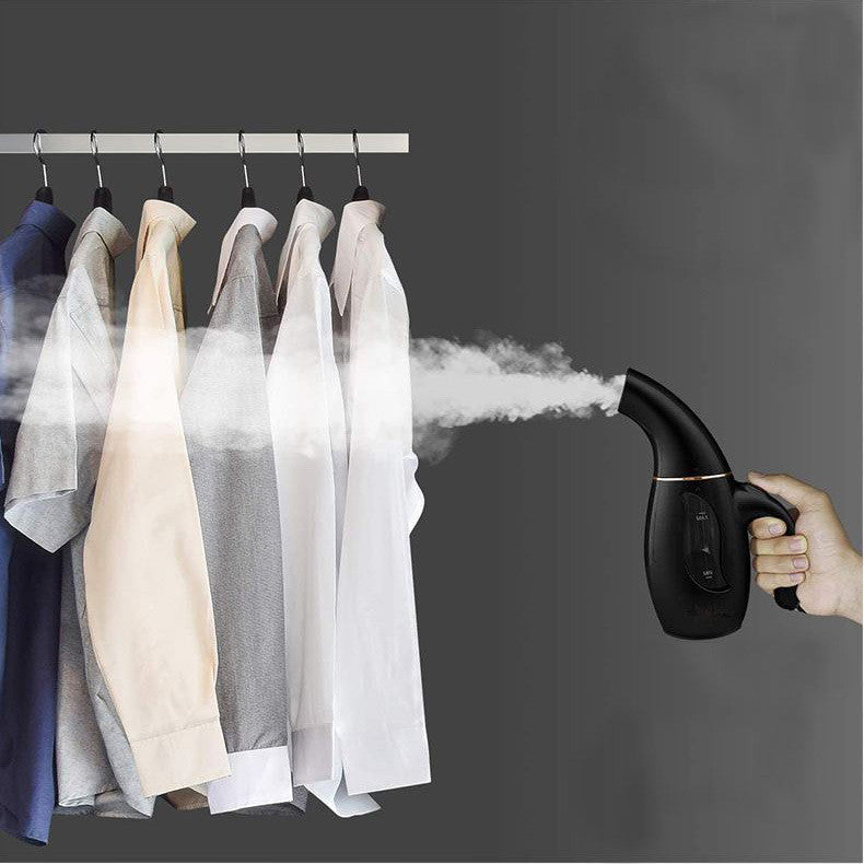 Woman using handheld garment steamer to remove wrinkles from clothes